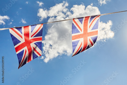 Fotografering British Union Jack bunting flags against sky