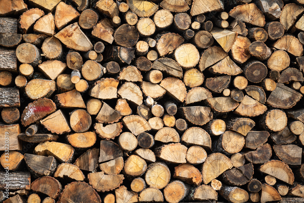 Firewood storage concept. Natural sawn wood stacked in row, texture. Stacks of chopped logs as background. Wallpaper. Firewood storage concept. Natural sawn wood stacked in row, texture. Stacks of chopped logs as background. Wallpaper.