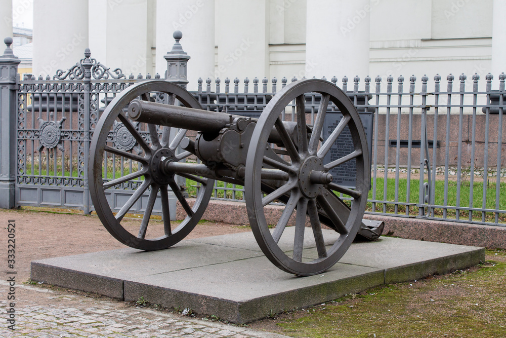 antique firearms cannon on a concrete pedestal