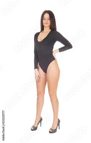 Woman standing in a black body suit from the front