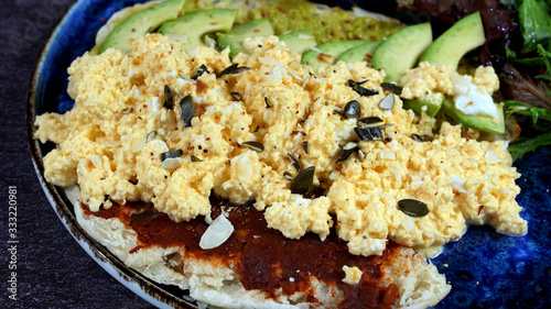 Avocado egg, tomato sauce and fresh salad photo