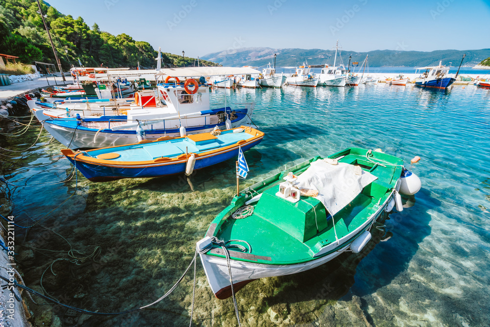 Colorful Greek local fishing boats in small port harbor of Kioni on Ithaka island, Greece