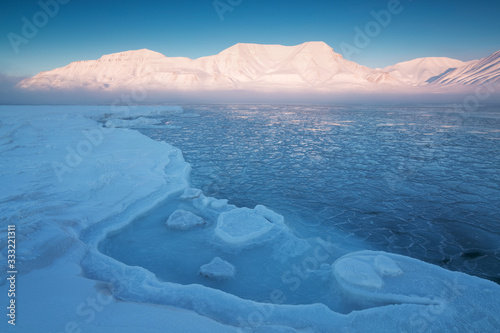 Norway landscape ice nature of the glacier mountains of Spitsbergen, Longyearbyen, Svalbard. Arctic ocean during winter polar day and colorful sunset sky Arctica area, Global warming Amazing nature 