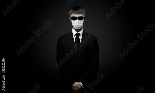 man in black costume in medical mask