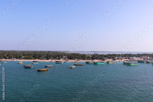 Ships Fisherman Boats Parked At Harbor or Harbour In Sea Oocean With Blue Water And Greenery At Coast. Natural Scenery Or Landscape