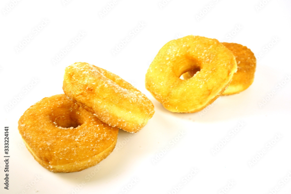 Brown donuts isolated on a white background, focus on the front, blurred back. Brown donuts isolated on a white background, focus on the front, blurred back.