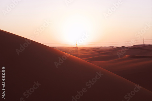 Bright sunrise on the red sand dunes of the Arabian desert in Riyadh, Saudi Arabia. New beginnings, symbol of hope and brighter tomorrow.