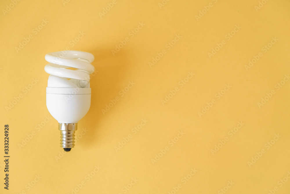 LED light bulb on yellow background. Top view. Copy, empty space for text LED light bulb on yellow background. Top view. Copy, empty space for text