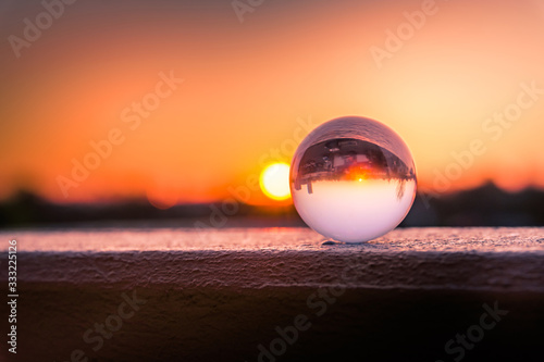 a glass ball in a red sunset in nature