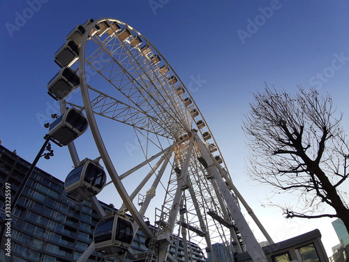 Fototapeta Naklejka Na Ścianę i Meble -  Ferris wheel against the sky seen from below