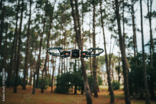 drone flying low in a forest