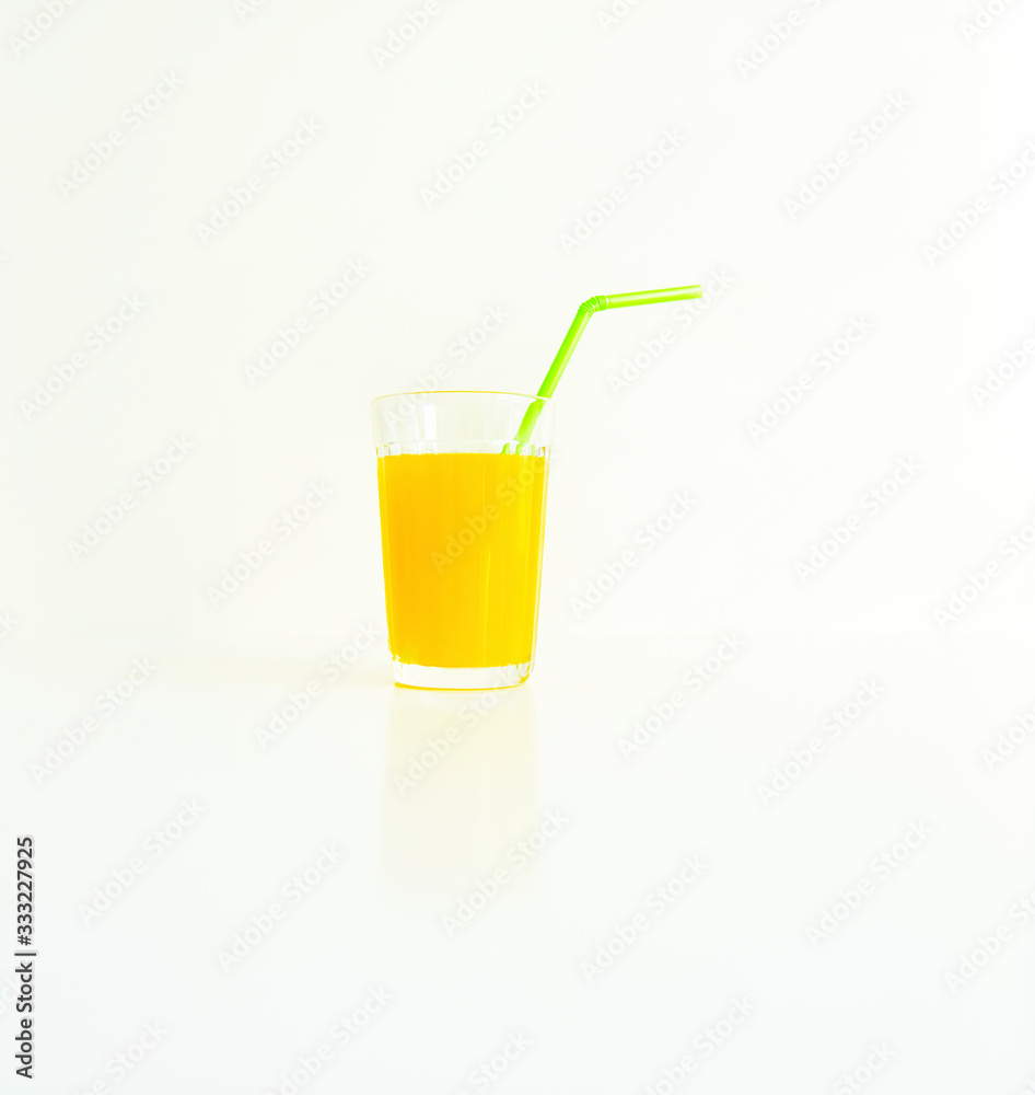 glass with yellow juice on a white background glass with yellow juice on a white background
