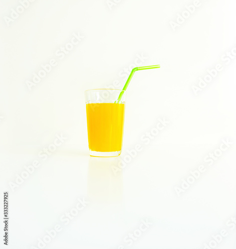 glass with yellow juice on a white background