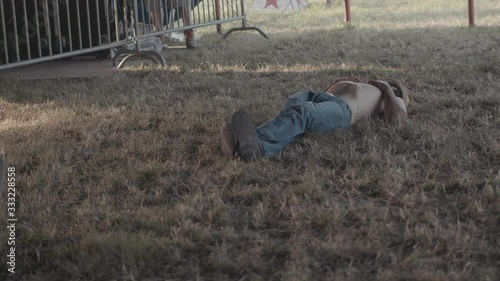 Man at festival sleeping on the grass photo