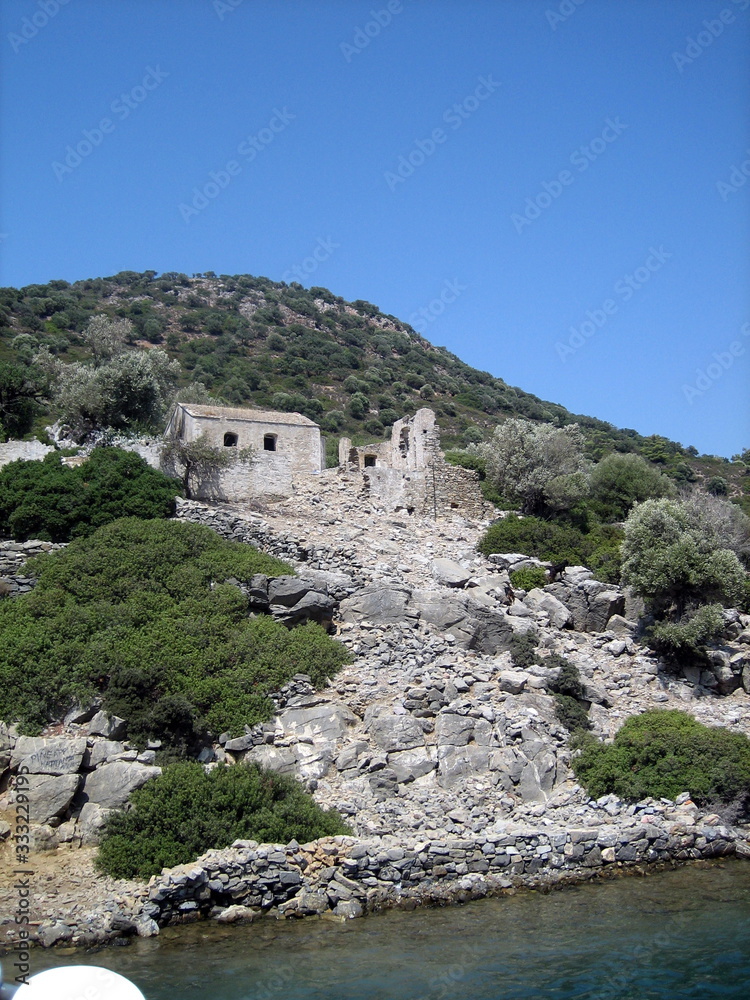 Mountainous sea coast with architectural monuments of antiquity, view from the water.