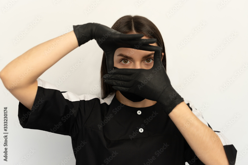 Coronavirus, a young girl in a black protective mask and black gloves, dressed in black clothes Coronavirus, a young girl in a black protective mask and black gloves, dressed in black clothes