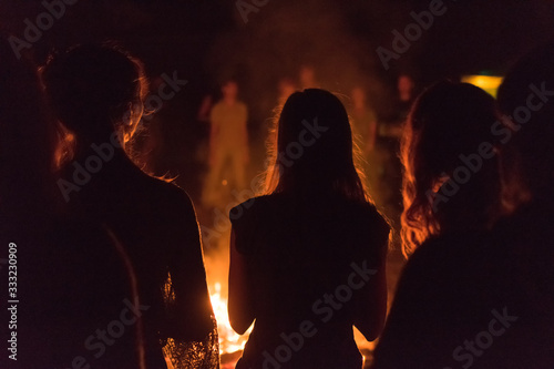   A lot of people around the fire at night at the festival. photo
