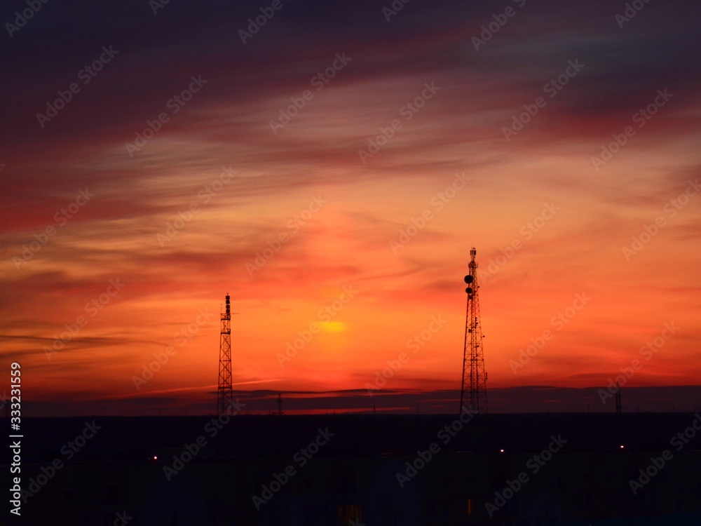  Orange sunset, colorful sky. The clouds. Electric tower.