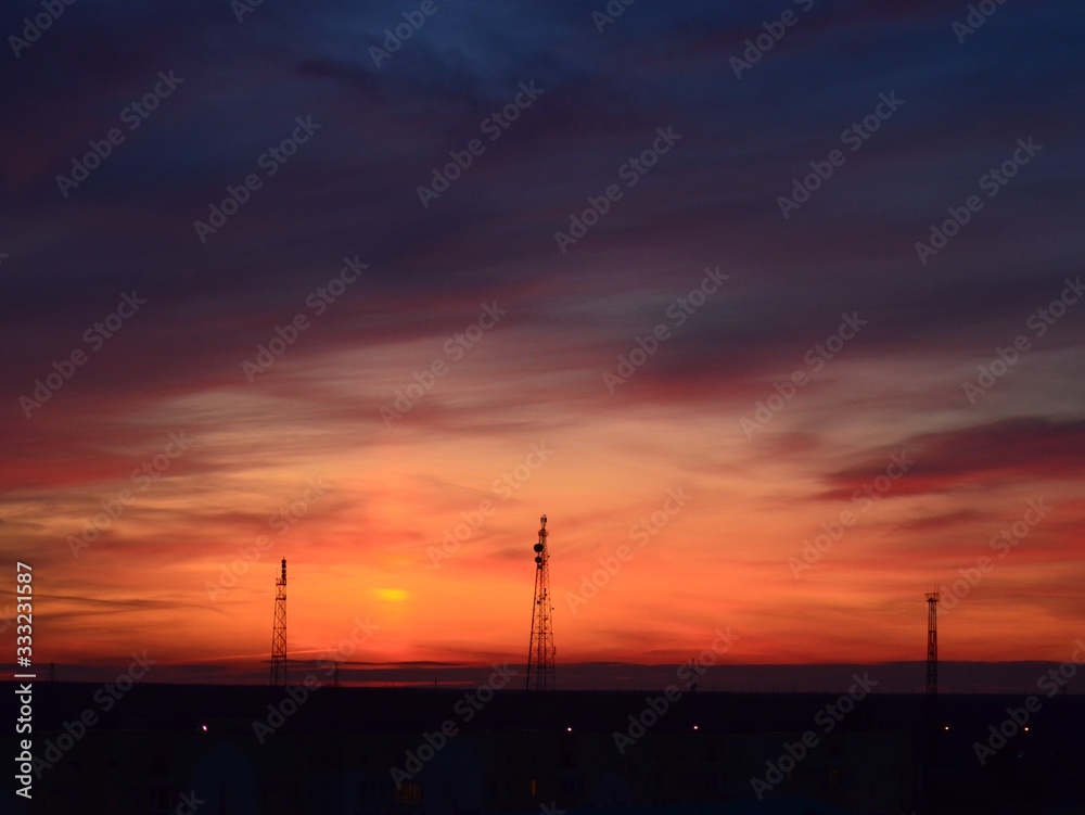  Orange sunset, colorful sky. The clouds. Electric tower.