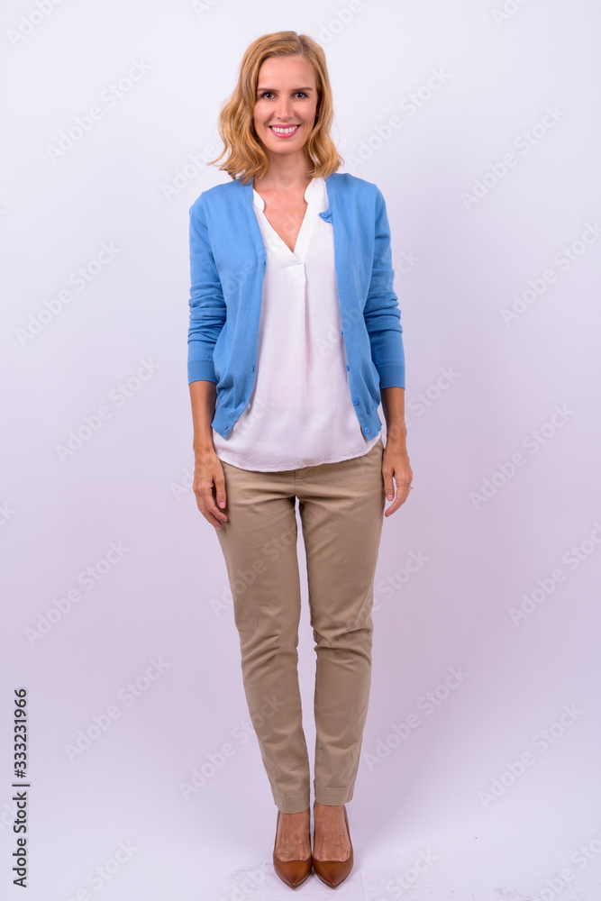Full body shot of happy beautiful blonde businesswoman smiling Full body shot of happy beautiful blonde businesswoman smiling