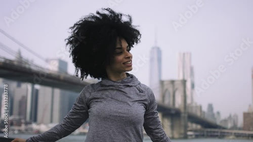 Female fitness model training outside in New York City with skyline and Brooklyn Bridge in background photo