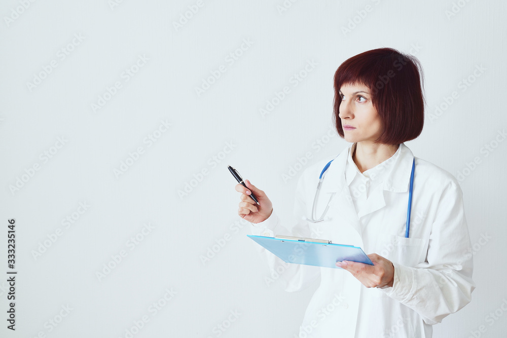 Female adult doctor stands on white background фтв shows, makes a hand gesture Female adult doctor stands on white background фтв shows, makes a hand gesture