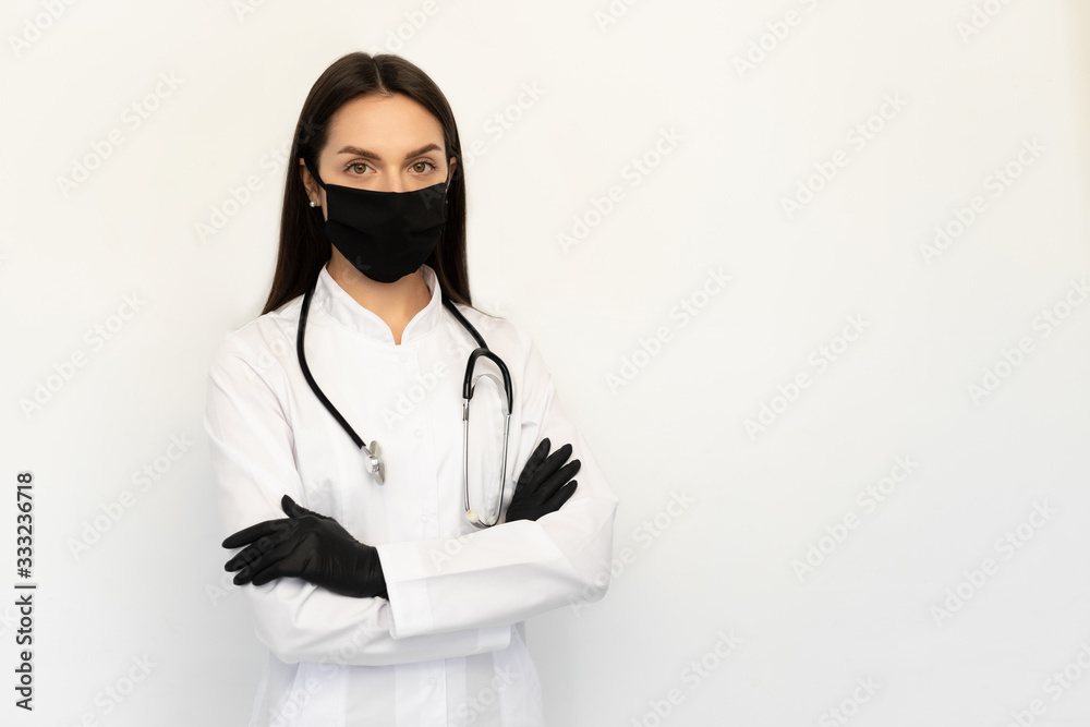Female doctor in black protective medical mask and black gloves, a stethoscope on neck Female doctor in black protective medical mask and black gloves, a stethoscope on neck