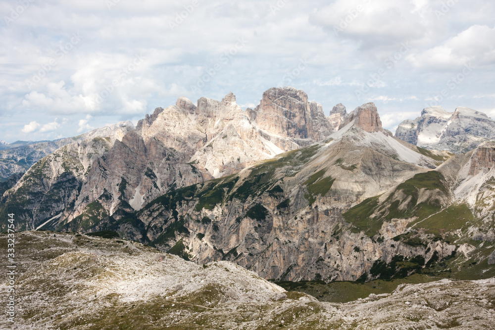 Panorama of Dolomites mountains with clouds. National Park Tre Cime di Lavaredo, Alps mountain chain, Trentino Alto Adige region, Sudtirol, Italy