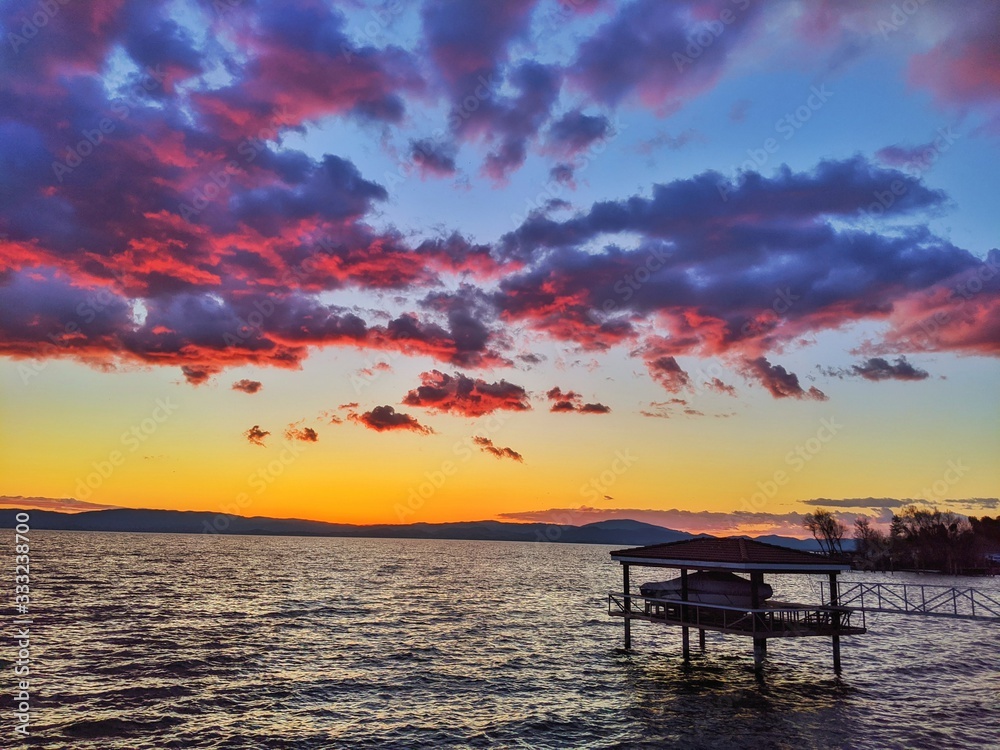 Red Sunset on Lake against Mountains