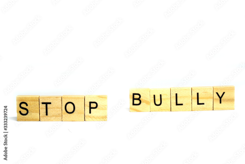 Stop Bully word wooden object isolated white background and copy space - Bullying is the use of force, coercion, or threat, to abuse, aggressively dominate or intimidate. Do not do that concept Stop Bully word wooden object isolated white background and copy space - Bullying is the use of force, coercion, or threat, to abuse, aggressively dominate or intimidate. Do not do that concept
