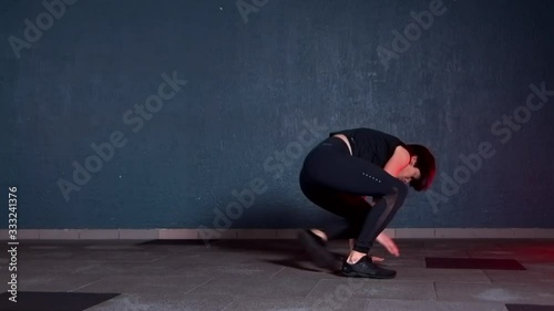 girl doing exercise in the yoga room. She makes body dance elements animal flow. Beautiful and graceful body movements in the style of animals.