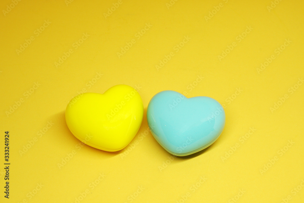 Couple ( 2 ) Blue and Yellow Heart on yellow Background - Valentine Day - Lover Concept with Copy space Couple ( 2 ) Blue and Yellow Heart on yellow Background - Valentine Day - Lover Concept with Copy space