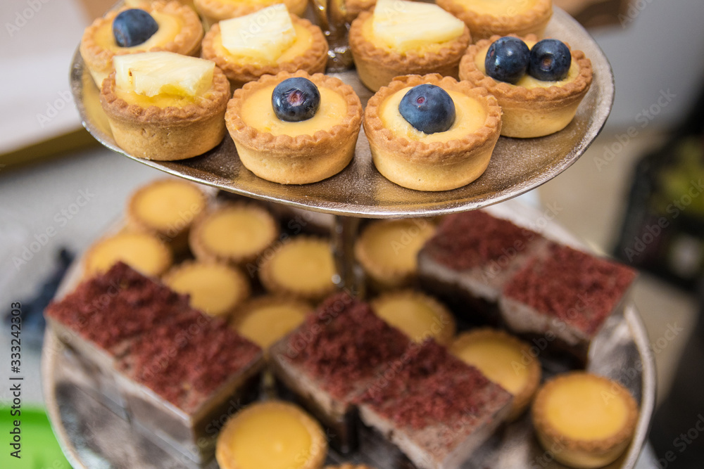 Fruit tartlets dessert and pastry cake sweets on trays