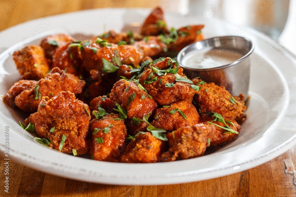 Boneless buffalo wings with sauce in bowl