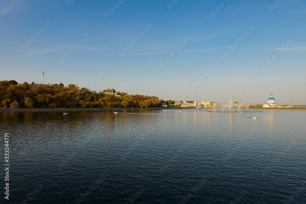September 26, 2019: Photo of the Cheboksary Bay with a fountain and people riding in boats and catamarans. Cheboksary. Russia. September 26, 2019: Photo of the Cheboksary Bay with a fountain and people riding in boats and catamarans. Cheboksary. Russia.