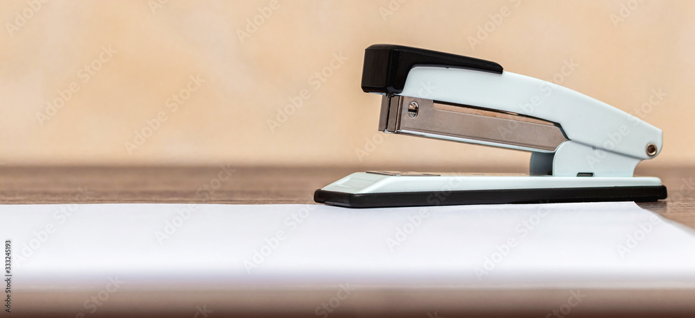 Stapler near sheets of white paper, copy space_ Stapler near sheets of white paper, copy space_