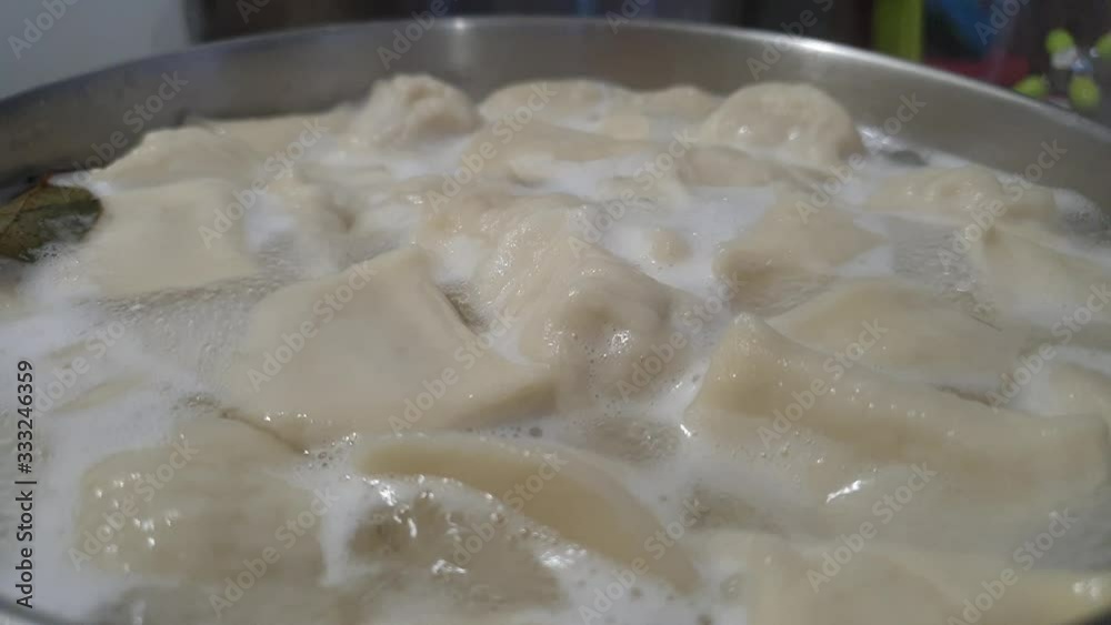 Cooking dumplings. Boiling dumplings with meat in a pan. Cooking dumplings. Boiling dumplings with meat in a pan.