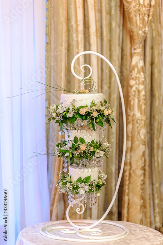 three-tier hanging cake with floral decorations