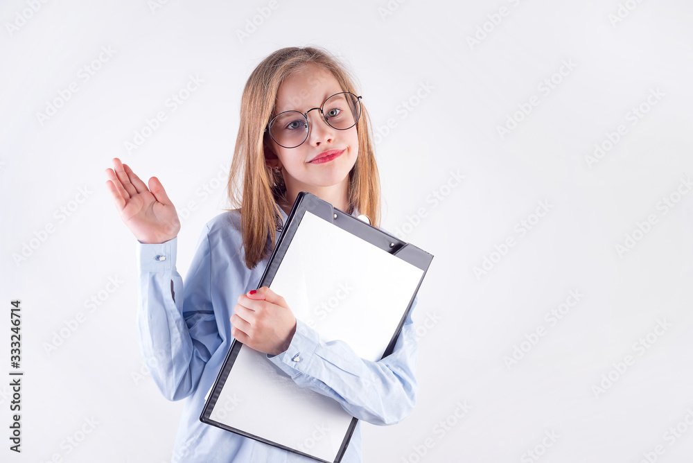 Young girl in glasses and mockup paper clipboard in her hand against light grey background. Young girl in glasses and mockup paper clipboard in her hand against light grey background.