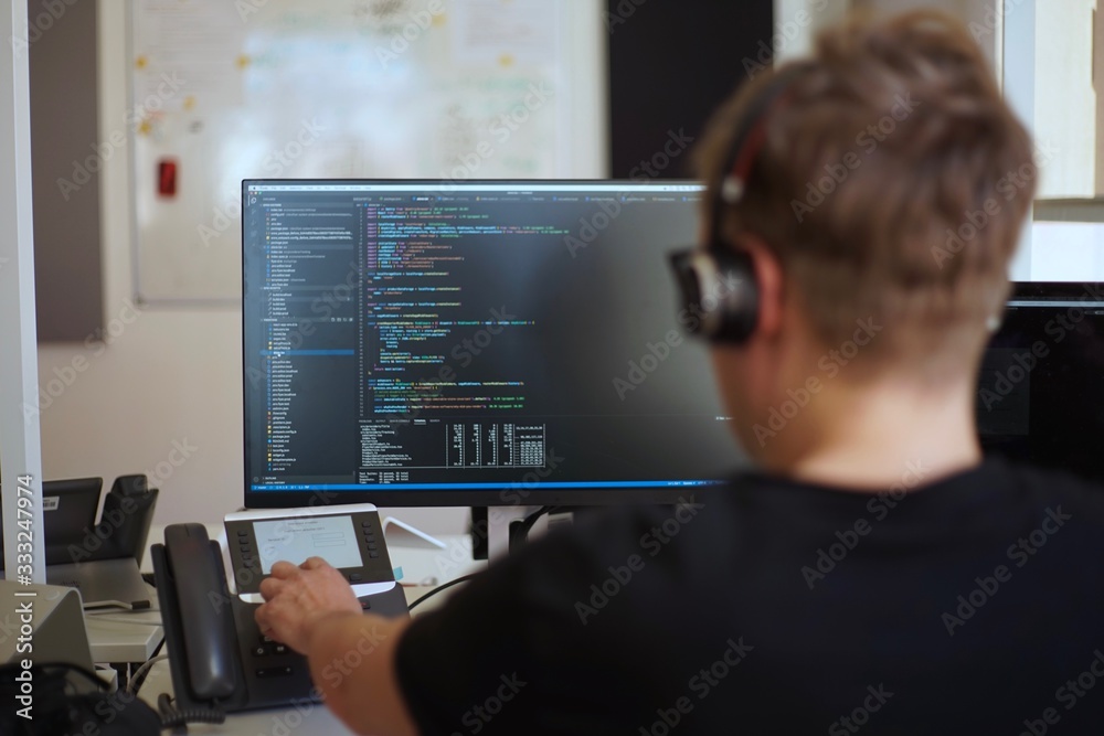 Real male web programmer coding javascript, php, symfony, react at work Real male web programmer coding javascript, php, symfony, react at work