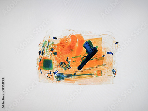 Xray of luggage with a hidden pistol photo