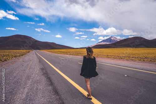 Young woman walking on a highway © jevgenia