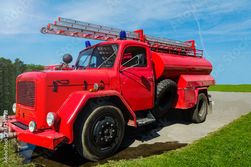 Old red fire truck used by voluntary fire brigade.