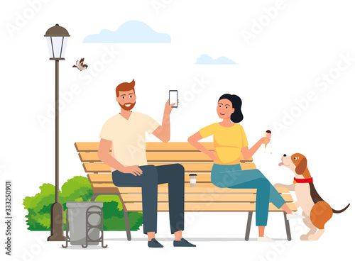 Man and woman sitting on a bench chatting in a park