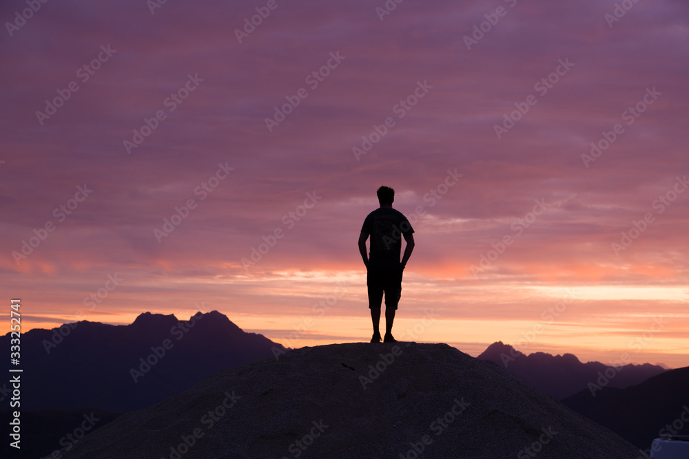 Silhouette of Man Against Colorful Sunset