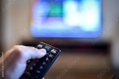 Bilde på lerret Stay at home concept photo with person holding a tv remote control zapping the n