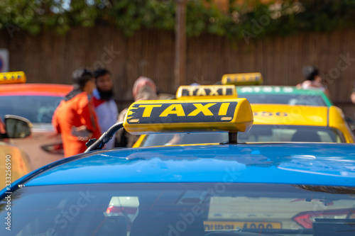 Taxi cars are waiting in row on the street - selective focus.