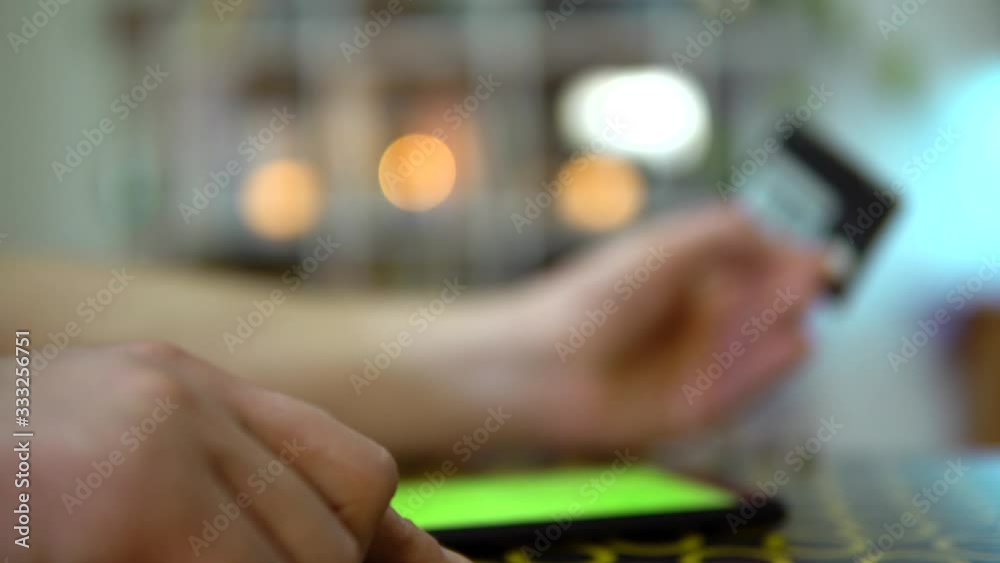 The phone is on the table, the guy doubts whether it is worth paying for the goods with a card. Internet fraud. The phone is on the table, the guy doubts whether it is worth paying for the goods with a card. Internet fraud.