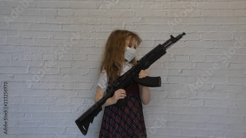 Wallpaper Mural the girl with a gun and a mask on her face during the epidemic Torontodigital.ca