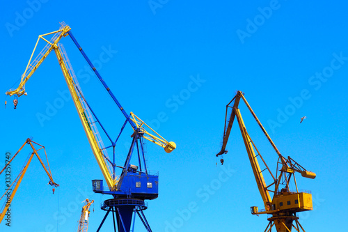 Wallpaper Mural beautiful yellow naval cranes, standing out against the azure blue sky of the port of Piraeus, near Athens in Greece Torontodigital.ca